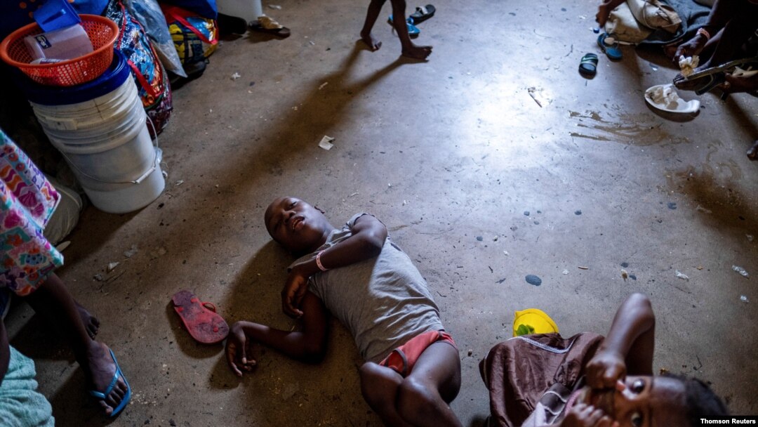 People shelter inside a school after their settlement was burned down by gangs in Port-au-Prince, July 27, 2021.
