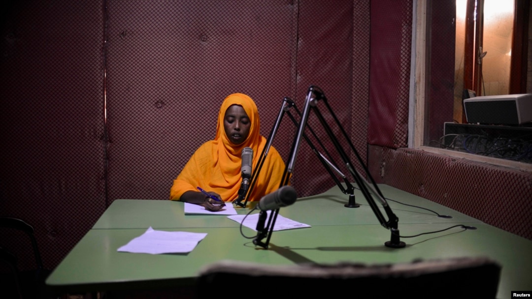 Radio Shabelle presenters reads the news at station headquarters, Mogadishu, Dec. 8, 2012.