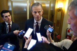 FILE - Sen. John Thune, R-S.D., answers reporters questions outside his office at the U.S. Capitol, Jan 29, 2020.