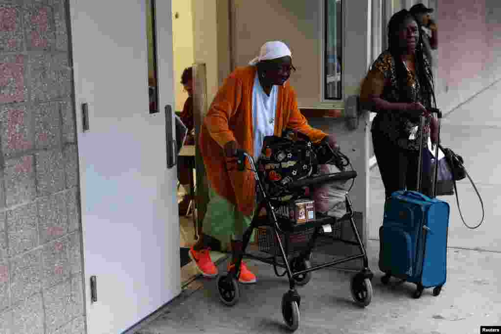 People leave a shelter for evacuees ahead of Hurricane Ian at Lockhart Elementary school in Tampa, Florida, Sept. 28, 2022.