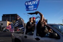 Supporters of President Donald Trump attend a rally and car parade Saturday, Aug. 29, 2020, in Clackamas, Ore., on the way to Portland.