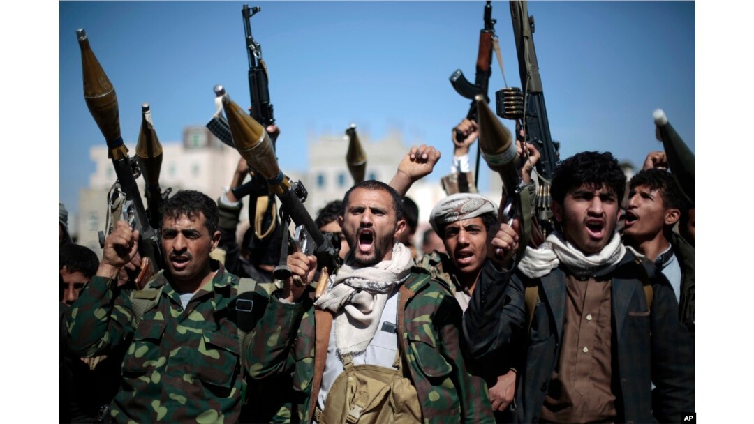 FILE - Tribesmen loyal to Houthi rebels hold their weapons as they chant slogans during a gathering to mobilize more fighters into battlefronts in several Yemeni cities, in Sana'a, Yemen, Nov. 24, 2016.