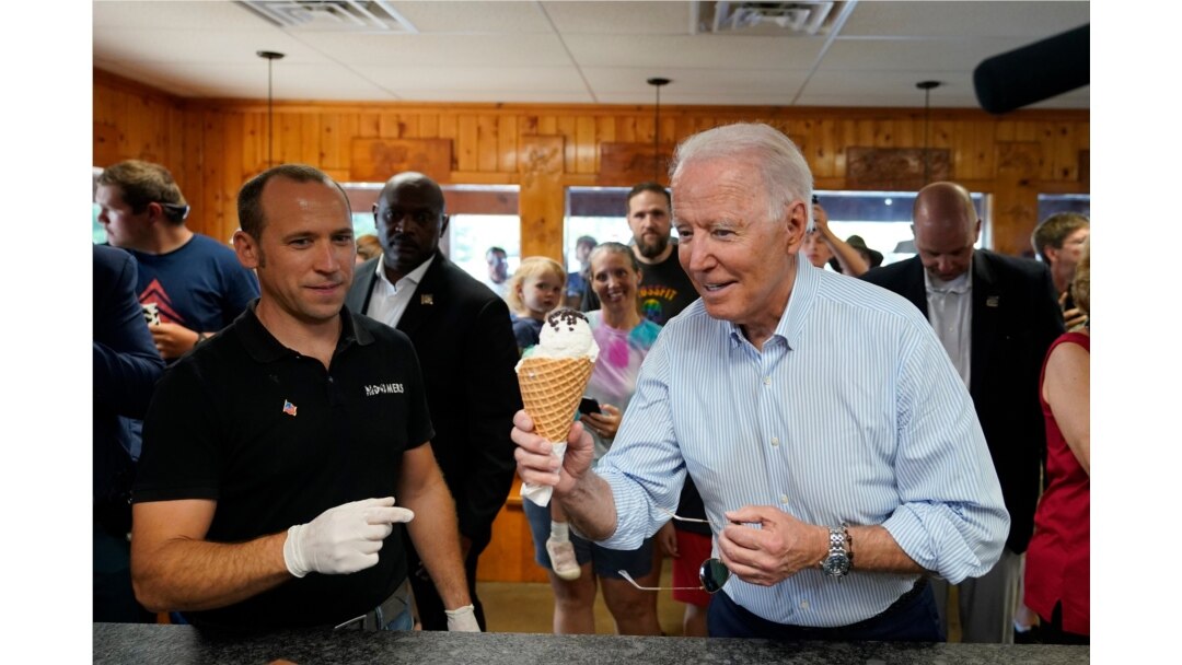President Joe Biden holds an ice cream cone as he visits Moomers Homemade Ice Cream in Traverse City, Mich., July 3, 2021.