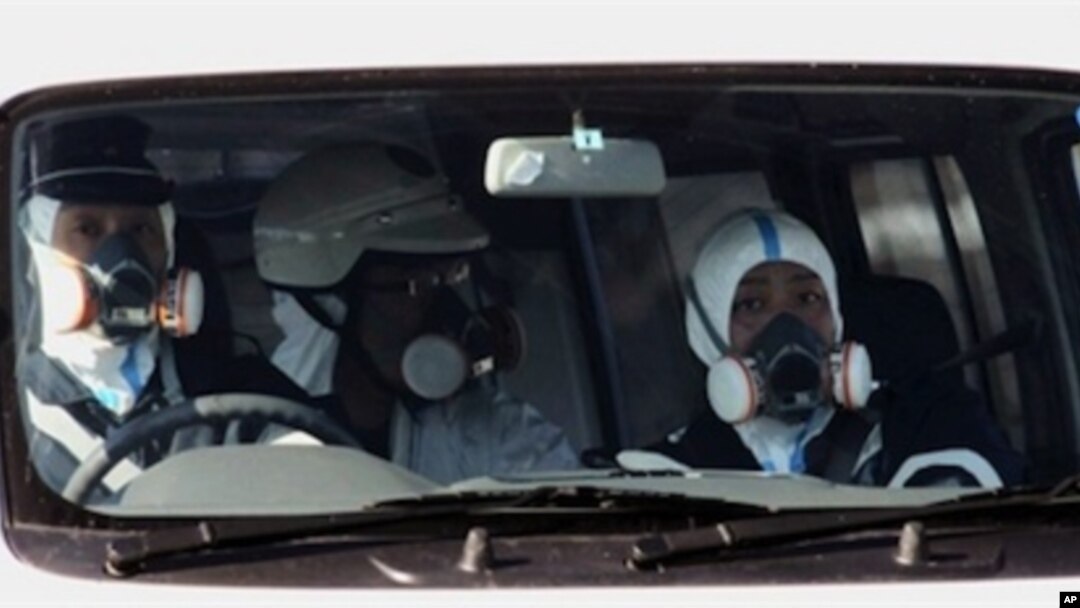 Policemen wear gas masks and patrol near the nuclear power plant in Fukushima prefecture on March 12, 2011 a day after a massive 8.9 magnitude quake and tsunami hit the region.
