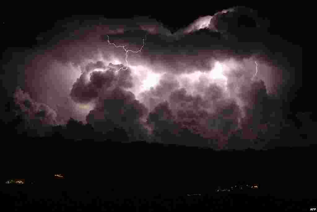 A long exposure photograph shows a lightning during a storm over the Taravo valley and the Petreto-Bicchisano village on the French Mediterranean Island of Corsica.