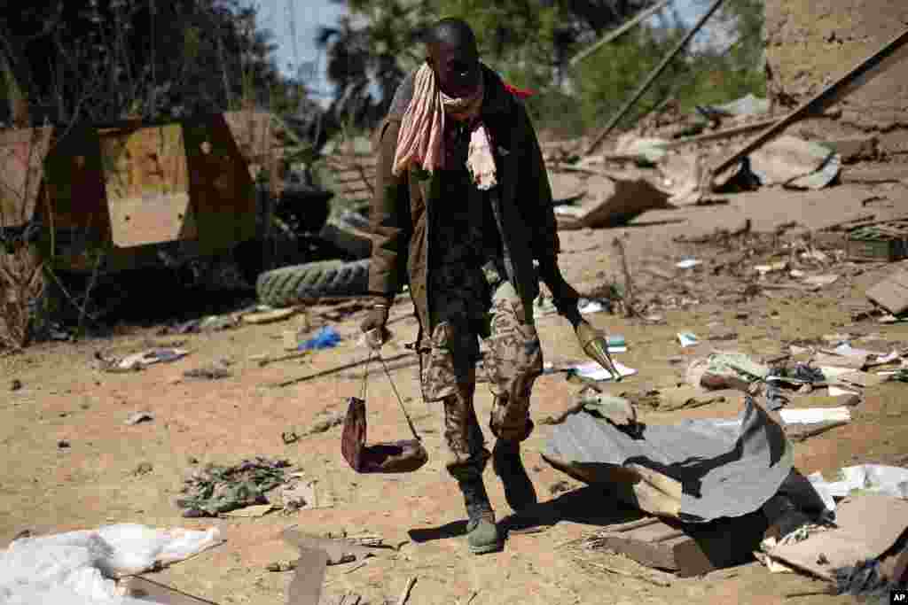 A Malian soldier walks inside a military camp used by radical Islamists and bombarded by French warplanes, in Diabaly, Mali, January 21, 2013.