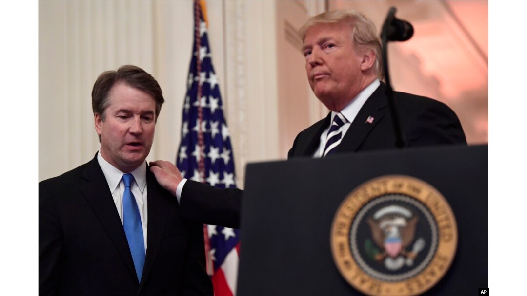 President Donald Trump, right, stands with Supreme Court Justice Brett Kavanaugh, left, before a ceremonial swearing in in the East Room of the White House in Washington, Monday, Oct. 8, 2018.
