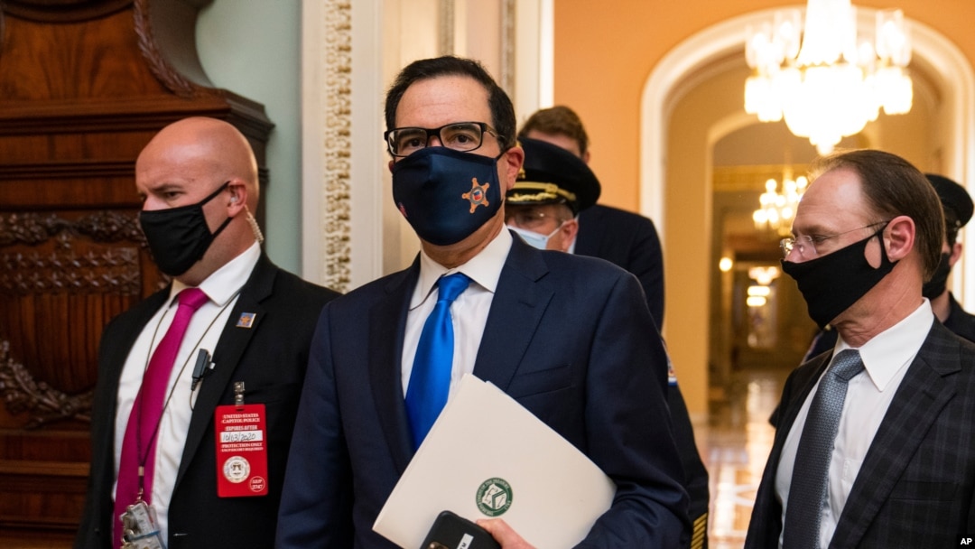 Treasury Secretary Steven Mnuchin makes a brief comment as he leaves the Capitol, Sept. 30, 2020, in Washington. Mnuchin earlier met with House Speaker Nancy Pelosi of California.