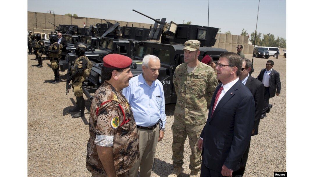 From right, U.S. Defense Secretary Ash Carter and Colonel Otto Liller, commander, 1st Special Forces Group Airborne greet Iraqi Major General Falah al Mohamedawi, left, at the Iraqi Counter Terrorism Service Academy in Baghdad, July 23, 2015.