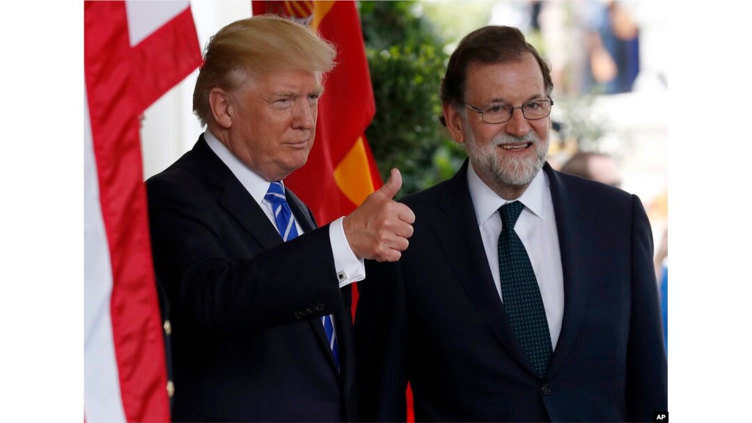 President Donald Trump gives thumbs up as he welcomes Spanish Prime Minister Mariano Rajoy at the White House, Sept. 26, 2017, in Washington.