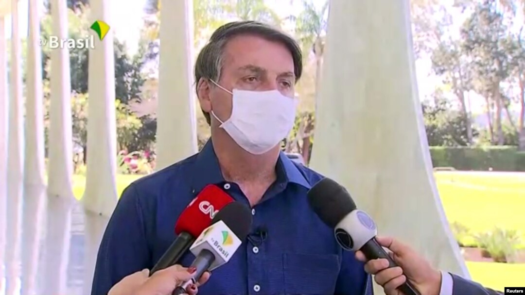Brazil's President Jair Bolsonaro confirms positive coronavirus diagnosis as he speaks to the media in Brasilia, Brazil, July 7, 2020.
