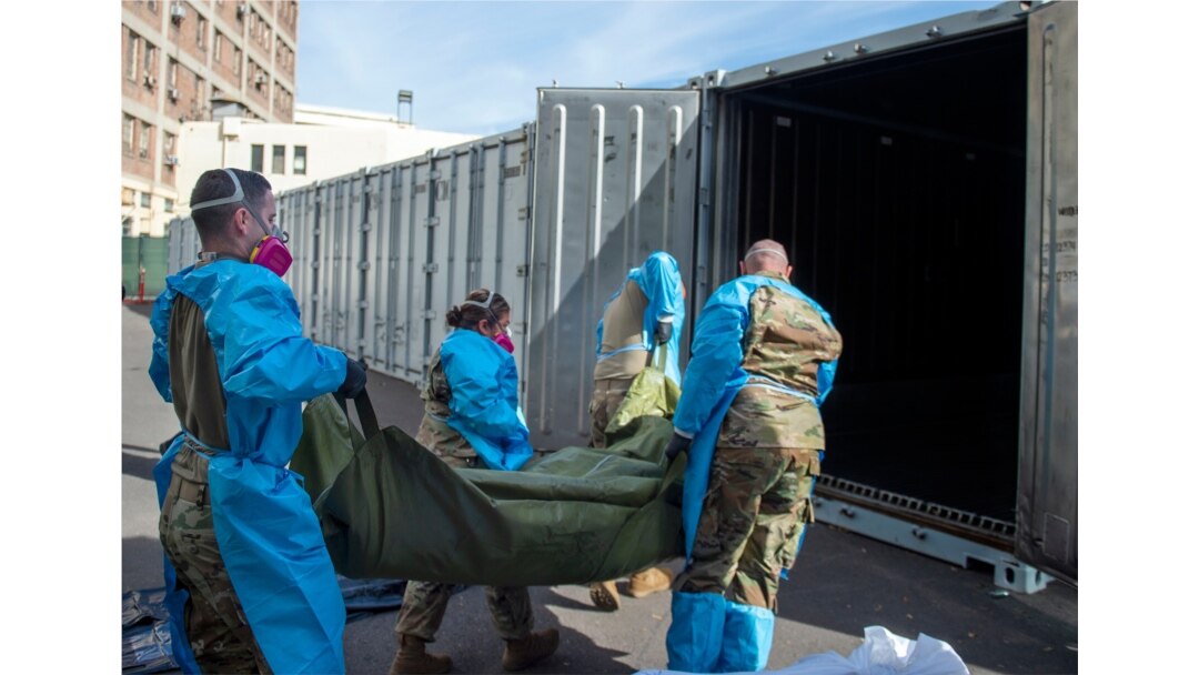In this Jan. 12, 2021 National Guard members are assisting with processing COVID-19 deaths, placing them into temporary storage at the medical examiner-coroner's office in Los Angeles.
