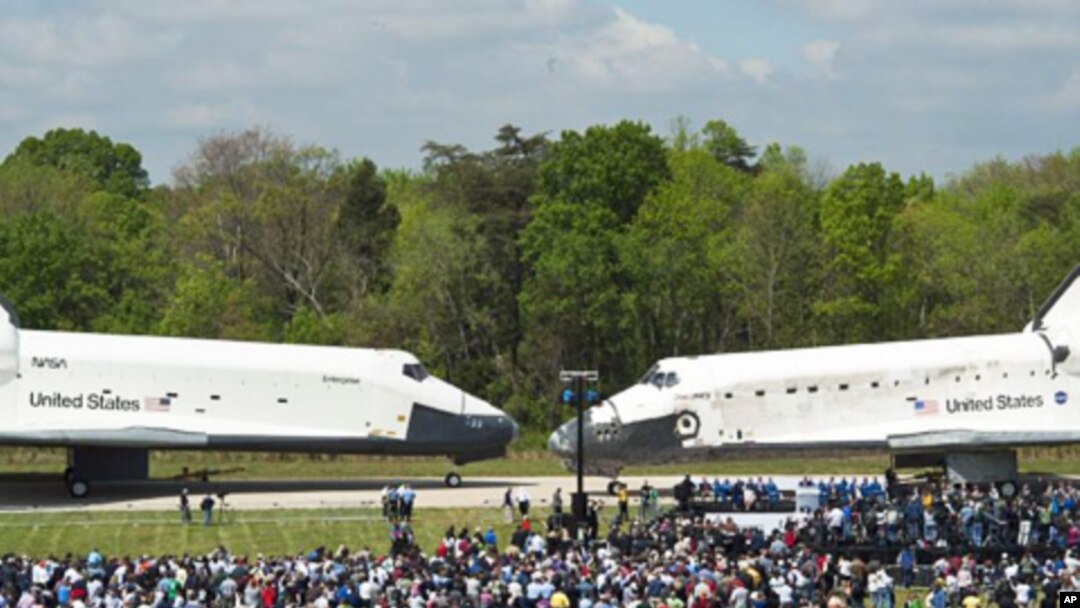 Space shuttles Enterprise (l) and Discovery meet nose-to-nose at the beginning of a transfer ceremony at the Smithsonian's Steven F. Udvar-Hazy Center in Chantilly, Virginia, April 19, 2012.