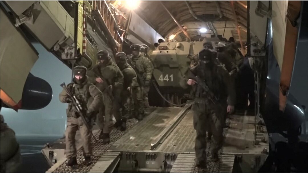 Russian service members disembark from a military aircraft, as part of a peacekeeping mission of the Collective Security Treaty Organisation amid mass protests in Almaty and other Kazakh cities, at an airfield in Kazakhstan, in this still image from video