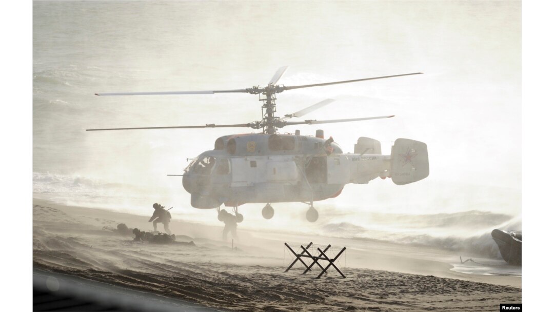 FILE - Servicemen take part in the joint war games Zapad-2013 (West-2013), at the Khmelevka range on Russia's Baltic Sea in the Kaliningrad Region, Sept. 26, 2013.