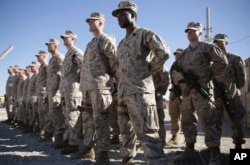 FILE - U.S. Marines stand guard during a change-of-command ceremony at Task Force Southwest military field in Shorab military camp of Helmand province, Afghanistan, Jan. 15, 2018.