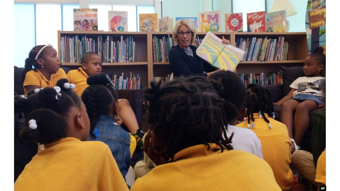 Education Secretary Betsy DeVos reads to students at Eagle Academy Public Charter School in Washington, Friday, June 2, 2017.