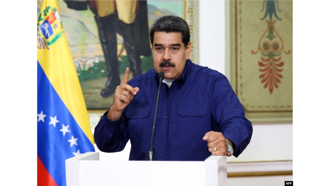 FILE - This handout picture released by the Venezuelan presidency shows President Nicolas Maduro speaking during a press conference at the Miraflores Presidential Palace in Caracas, March 11, 2019.