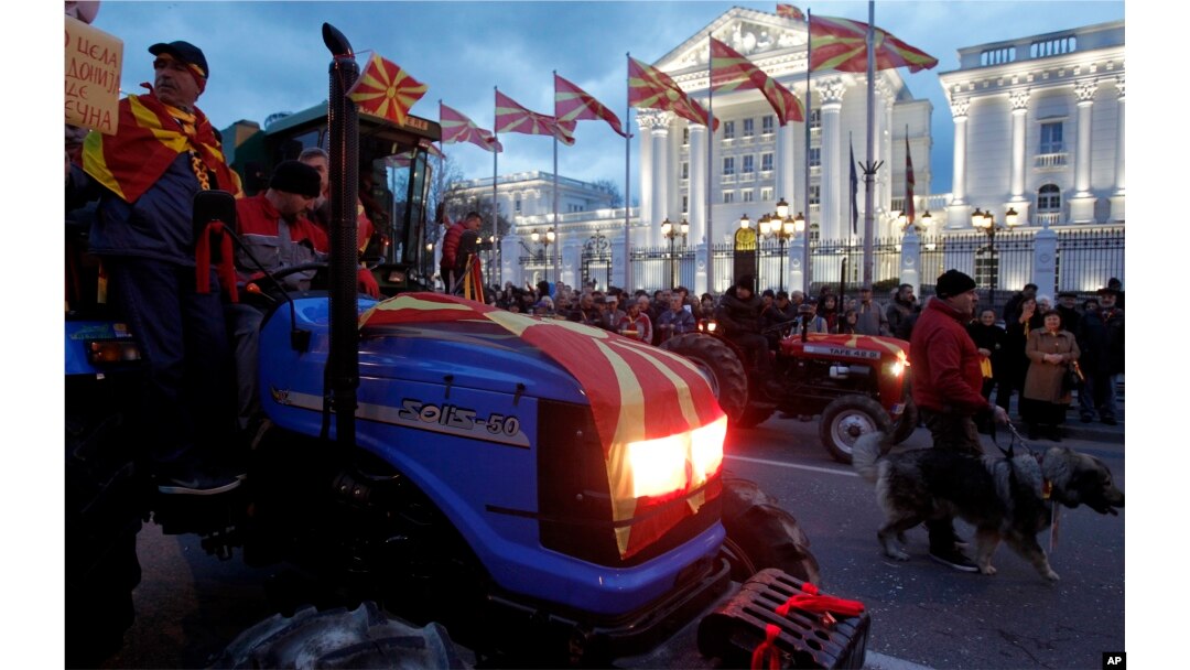 Farmers on tractors participate in a protest in front of the government building in Skopje, Macedonia, March 10, 2017. Thousands of ethnic Macedonians have held evening protests against three ethnic Albanian parties forming a coalition government with the Social Democrats.