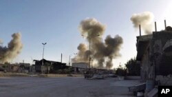This photo released by the Syrian Civil Defense White Helmets, which has been authenticated based on its contents and other AP reporting, shows smoke rising after Syrian government airstrikes hit in the town of Douma, in the eastern Ghouta region, east of Damascus, Syria, Saturday, April. 7, 2018.