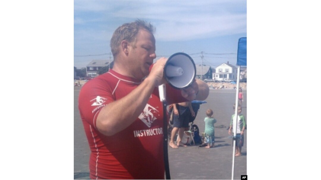 AmpSurf founder Dana Cummings commands the beach with his megaphone as he welcomes participants to a surfing class in Maine.