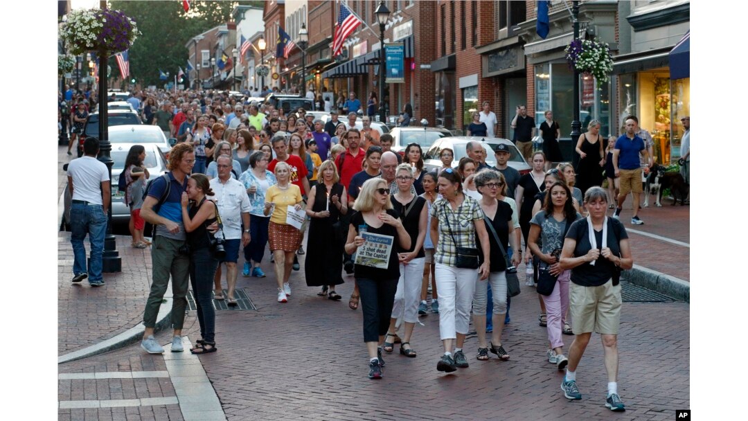 People walk in silence during a vigil in response to a shooting in the Capital Gazette newsroom, June 29, 2018, in Annapolis, Md.