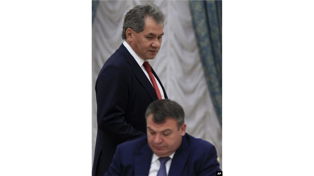 Governor of Moscow Region Sergei Shoigu passes by then Defense Minister Anatoly Serdyukov before a session of the State Council's Presidium at the Kremlin in Moscow, October 9, 2012.
