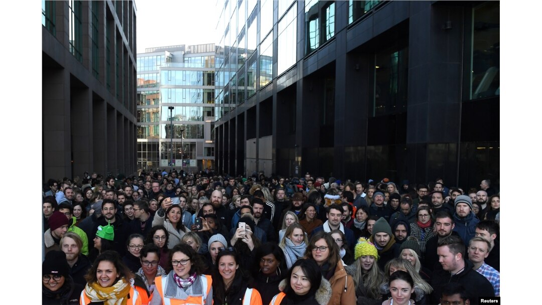 Workers stand outside the Google offices after walking out as part of a global protest over workplace issues in Dublin, Ireland, Nov. 1, 2018.