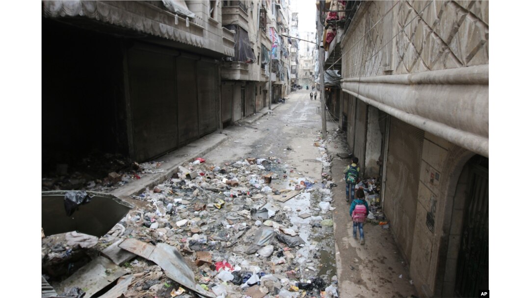 FILE - Children walk down a street in Aleppo, Syria, Feb. 11, 2016.