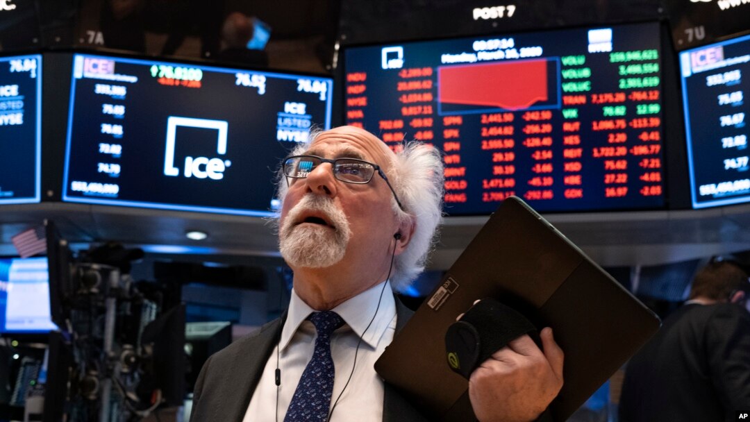 Trader Peter Tuchman works on the floor of the New York Stock Exchange Monday, March 16, 2020. (AP Photo/Craig Ruttle)