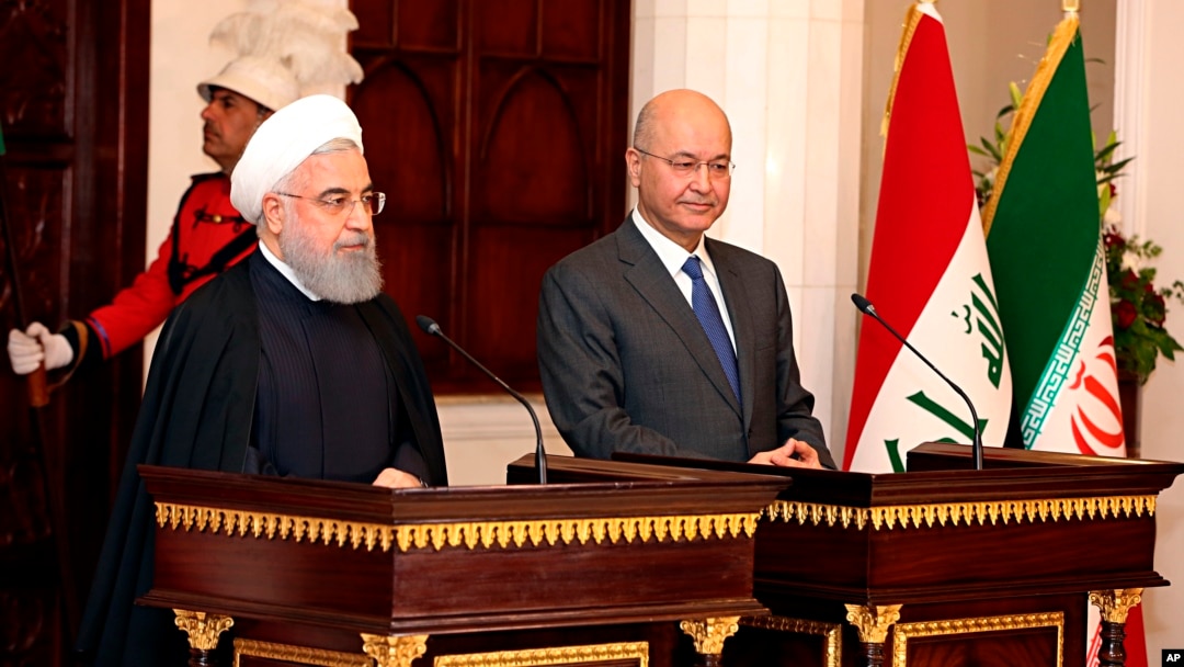 Iraqi President Barham Salih, right, and Iranian President Hassan Rouhani hold a press conference at Salam Palace in Baghdad, Iraq, March 11, 2019.