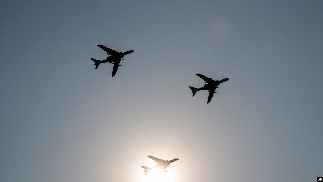 FILE - China's H-6 bomber jets fly in formation past the sun during a parade to commemorate the 70th anniversary of the founding of Communist China in Beijing, Oct. 1, 2019. 