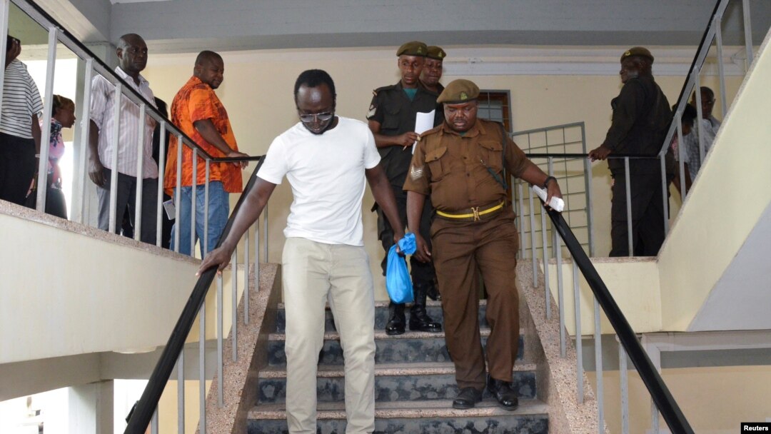 Tanzanian investigative journalist Erick Kabendera leaves after he appeared at the Kisutu residents magistrate court in Dar es Salaam, Tanzania, Sept. 12, 2019.
