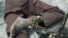 FILE - A patient at a home for the mentally ill is chained to a table in Monrovia, Liberia, Aug. 29, 2003.