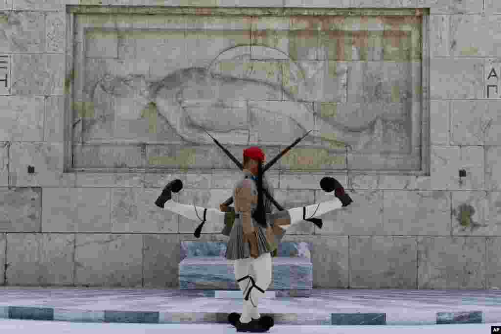 Evzones of the Greek Presidential Guard in front of the Tomb of the Unknown Soldier in Athens Greece.