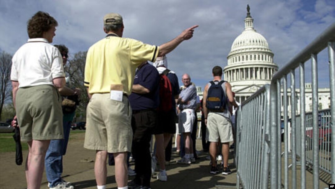 FILE -- Tourists line up outside the U.S. Capitol in Washington.