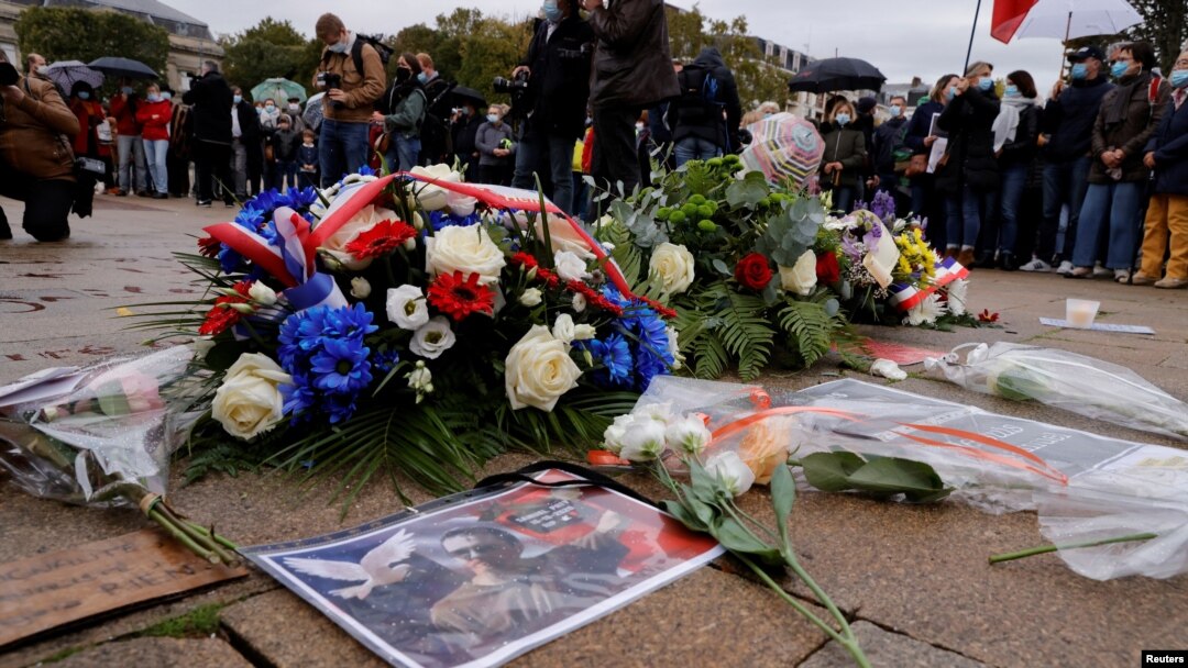 Floral tributes to Samuel Paty, the French teacher who was beheaded on the streets of the Paris suburb of Conflans St Honorine, are seen at the Place de la Republique, in Lille, France, Oct. 18, 2020. (Reuters)