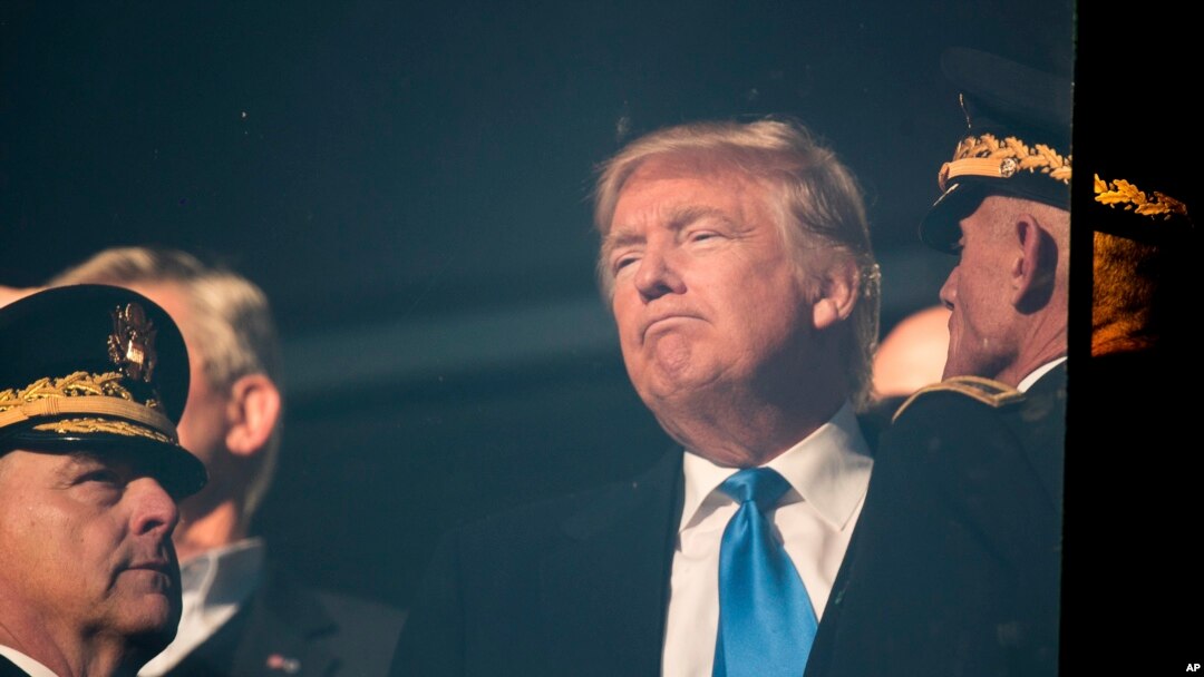 FILE - President-elect Donald Trump, center, listens to a member of the military in Baltimore, Dec. 10, 2016. Plans to put more money into infrastructure and the military may push inflation too high, one central bank leader says.