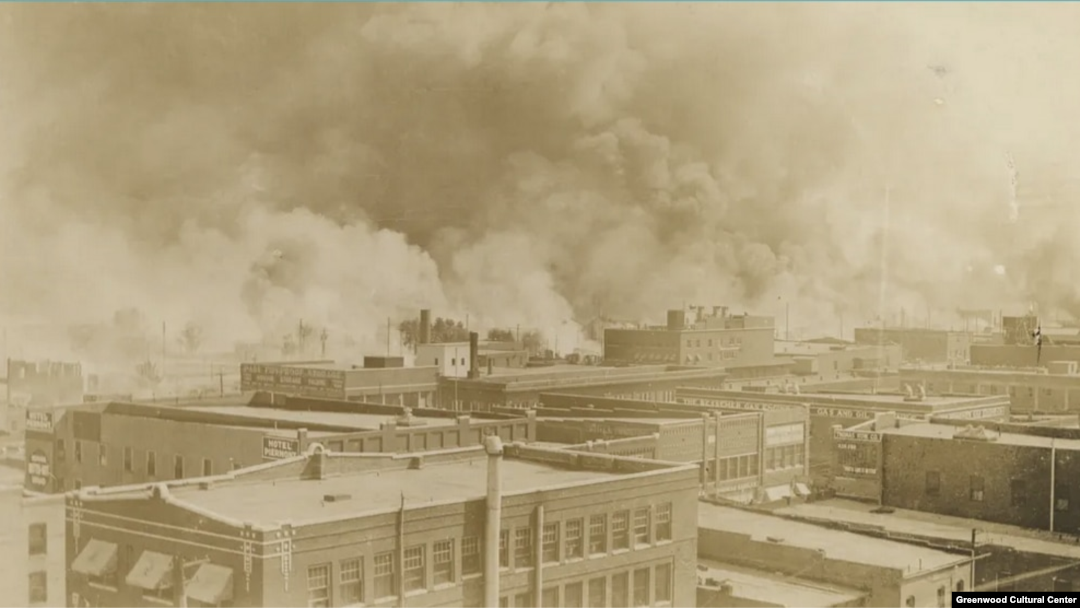 Black Wall Street burns in Tulsa, Oklahoma, June 1921. (Courtesy Greenwood Cultural Center)