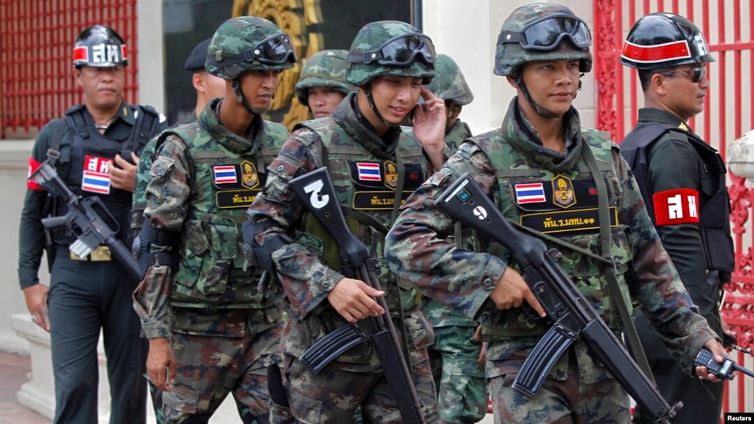 FILE - Soldiers patrol around the Royal Thai Army Headquarters as members of the Radio and Satellite Broadcasters gather in Bangkok, June 18, 2014. 