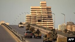 Fighters of a military battalion loyal to Libyan General Khalifa Hafta patrol the streets in the eastern city of Benghazi during a state of emergency to combat the coronavirus disease outbreak, March 21, 2020. 
