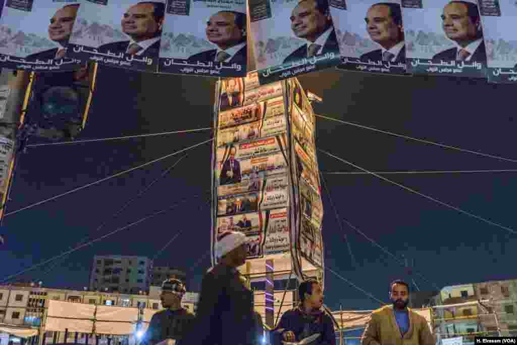 Pedestrians pass pro-Sissi banners in northern Cairo's al-Matarya square, the scene in years past of demonstrations in support of the Muslim Brotherhood. (H. Elrasam/VOA)