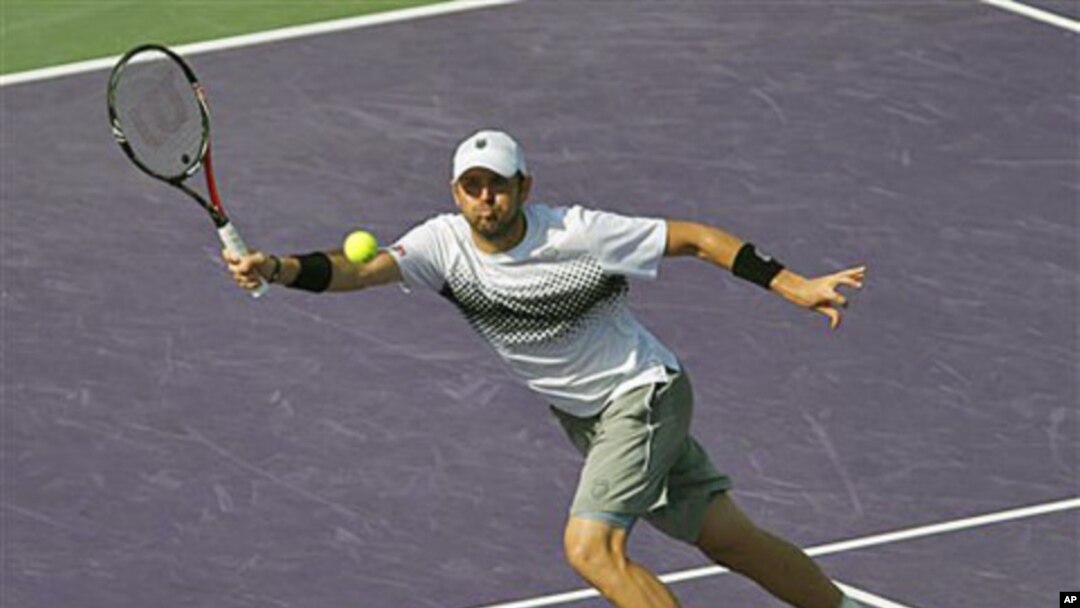 Mardy Fish returns a shot to David Ferrer at the Sony Ericsson Open tennis tournament in Key Biscayne, Fla., where Fish won the match 7-5, 6-2, March 30, 2011