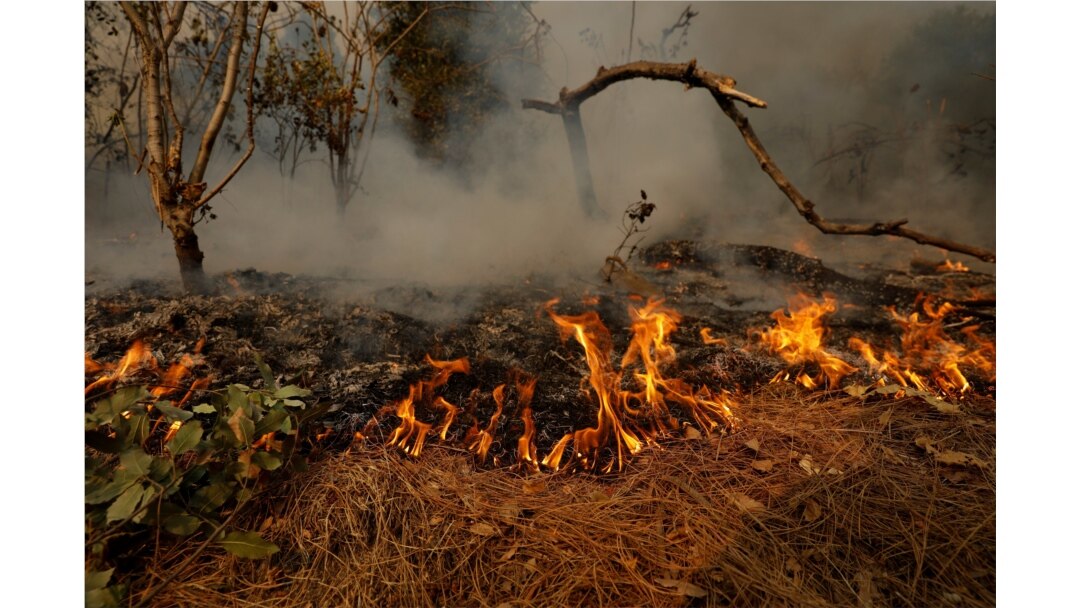 FILE - Flames and smoke from the Bobcat Fire are pictured after an evacuation was ordered for the residents of Arcadia, Calif., Sept. 13, 2020.