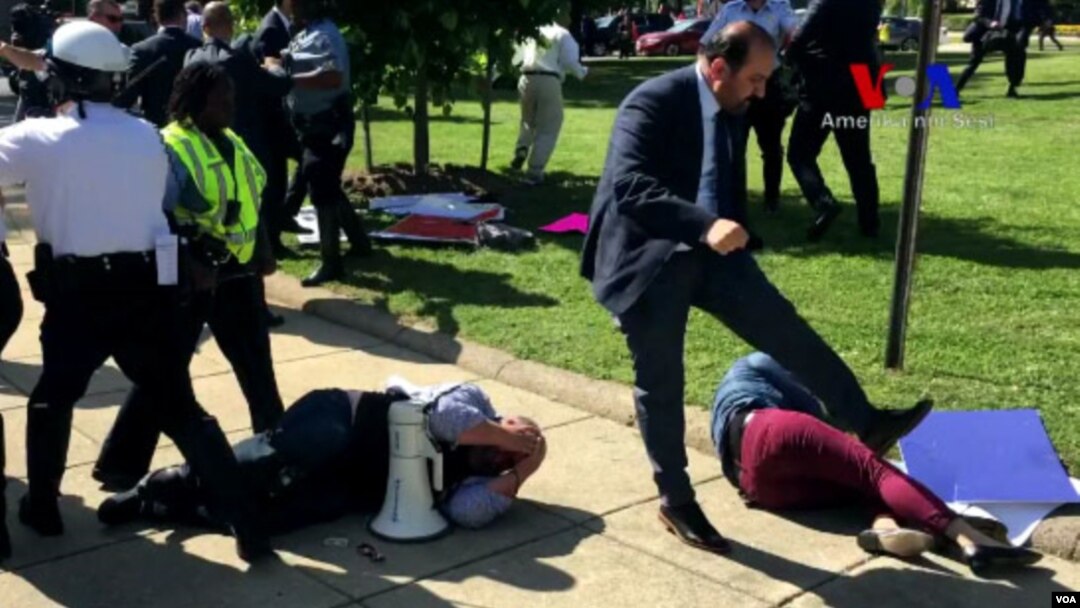 Demonstrators lie on the ground following a brawl with Turkish security personnel near the Turkish ambassador's residence in Washington, May 17, 2017. (Screengrab from VOA Turkish video)