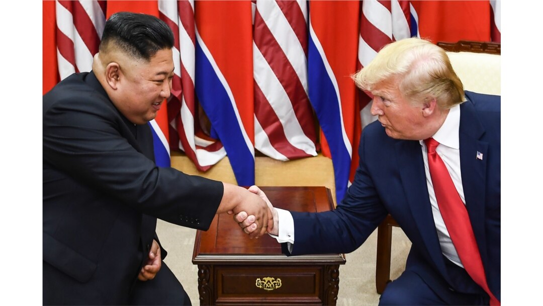 FILE - North Korea's leader Kim Jong Un (L) and US President Donald Trump shake hands during a meeting on the south side of the Military Demarcation Line that divides North and South Korea.