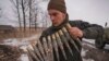 A Ukrainian serviceman carries large caliber ammunitions during an exercise in a Joint Forces Operation controlled area in the Donetsk region, eastern Ukraine, Feb. 10, 2022.
