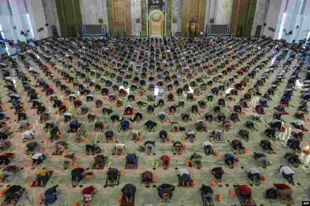 Muslims take part in congregational Friday prayers with social distancing measures in place due to the COVID-19 pandemic at a mosque in Surabaya, Indonesia.