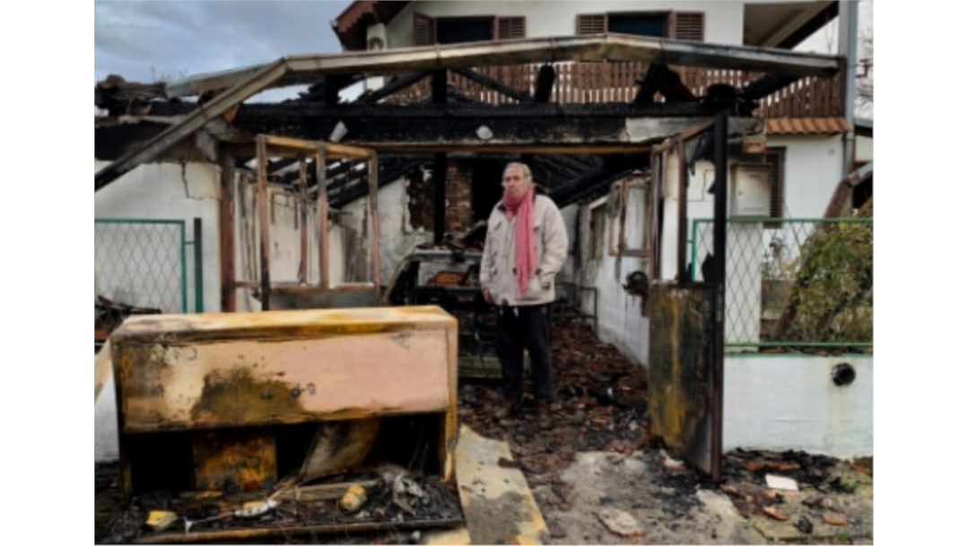 Milan Jovanovic in front of his burned home, in Belgrade, Serbia, December 2018.