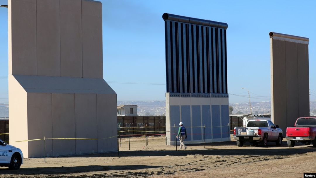FILE - Three of U.S. President Donald Trump's eight border wall prototypes are shown near completion along U.S.- Mexico border in San Diego, California, Oct. 23, 2017. 